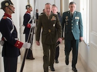 Marine Corps Gen. Joseph F. Dunford Jr., chairman of the Joint Chiefs of Staff, left, passes Colombian guards as he heads to a meeting with Colombian President Juan Manuel Santos at the Palacio de Narino in Bogota, Colombia, March 10, 2016. DoD photo by Navy Petty Officer 2nd Class Dominique A. Pineiro