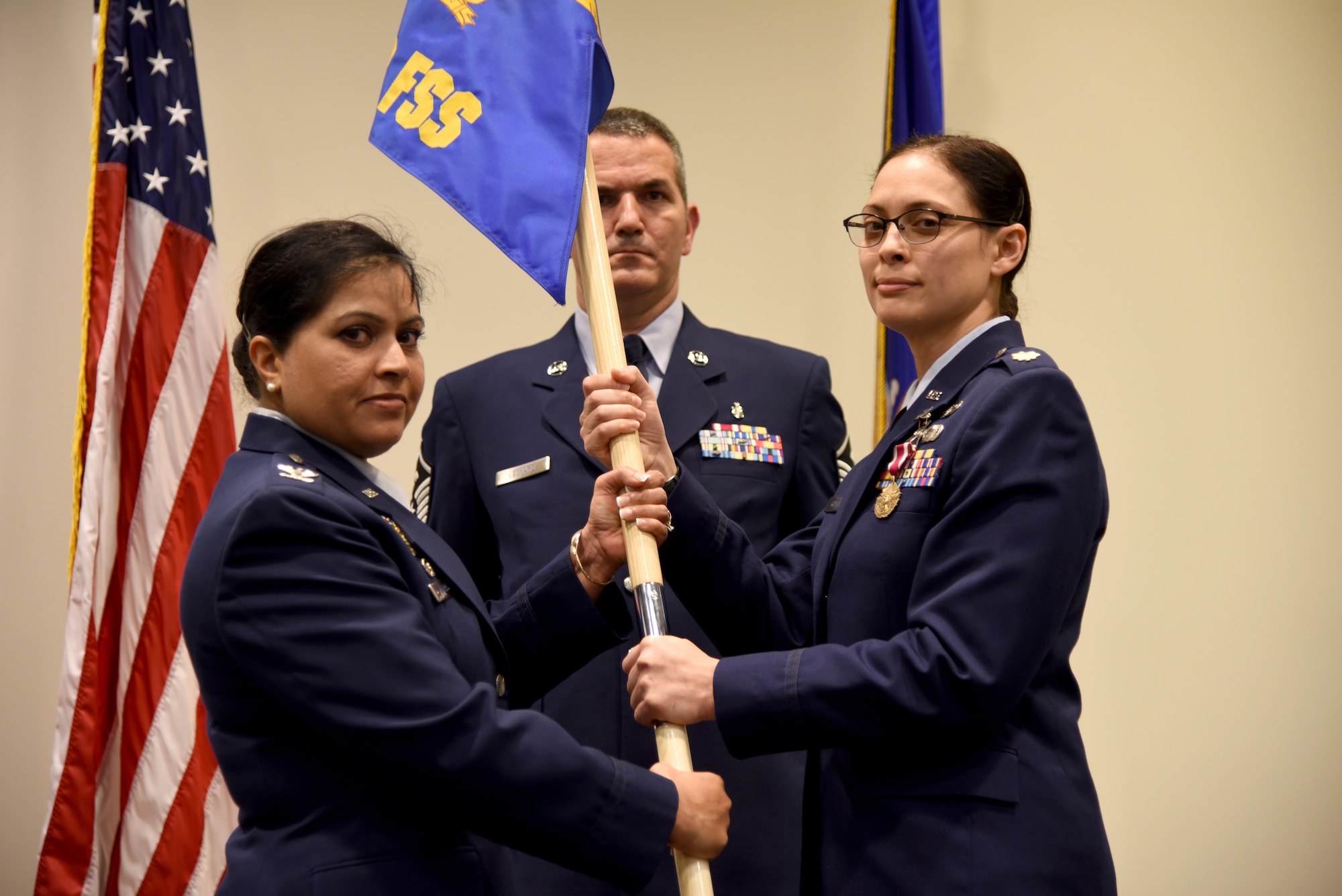 Col. Beena Maharaj, commander of the 403rd Mission Support Group, hands over the guidon for the 403rd Force Support Squadron to Maj. Lisa Kostellic, the new commander of the 403rd FSS during the assumption of command ceremony held here March 6, 2016. (U.S. Air Force photo/Staff Sgt. Nicholas Monteleone)
