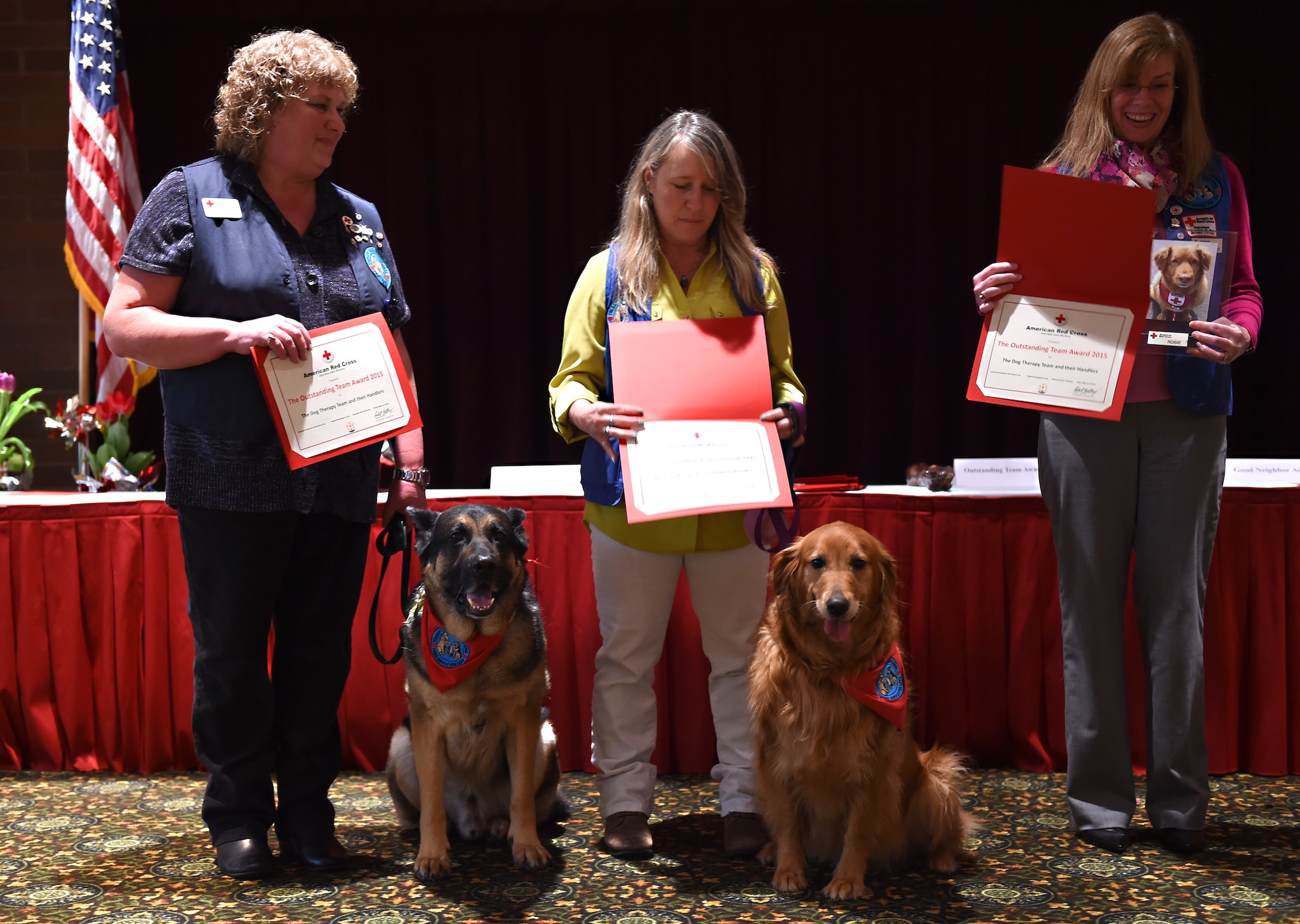 The Joint Base Lewis-McChord American Red Cross dog therapy team and their handlers receive the Outstanding Team Award at the Joint Base Lewis-McChord Annual Volunteer Recognition Luncheon and Award Ceremony at the McChord Club, JBLM, Wash., March 9, 2016. The therapy dogs and their handlers play a critical role in providing services to the JBLM community including visits to the Madigan Army Medical Center. (U.S. Air Force photo/Staff Sgt. Naomi Shipley)
