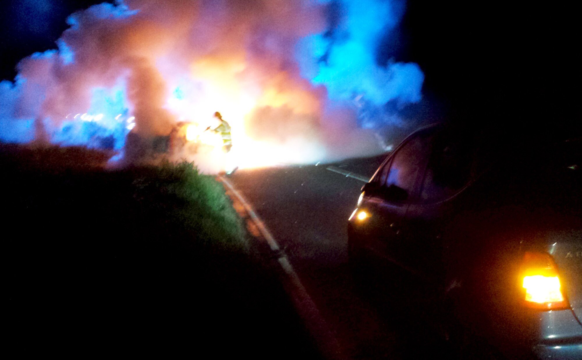 A vehicle is engulfed in flames after being involved in a three-car accident May 12, 2014, near RAF Mildenhall, England. Staff Sgt. Vicente Gomez, 100th Aircraft Maintenance Squadron crew chief, performed life-saving assistance to the victims of the crash. Gomez was presented with the Airman’s Medal for his courageous acts. (Courtesy photo)
