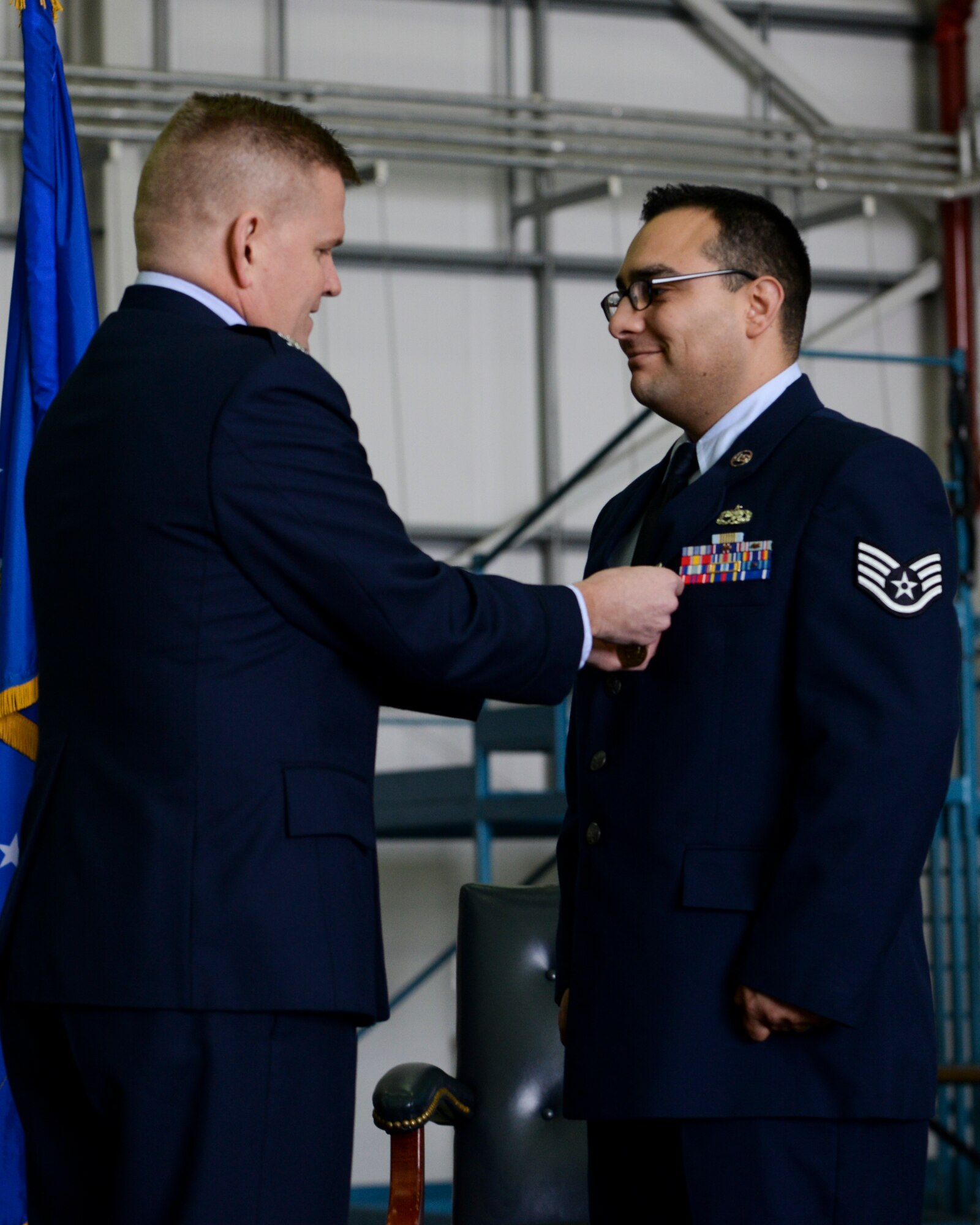 U.S. Air Force Col. Thomas D. Torkelson, 100th Air Refueling Wing commander, presents Staff Sgt. Vicente Gomez, 100th Aircraft Maintenance Squadron crew chief, with the Airman’s Medal during a ceremony March 11, 2016, on RAF Mildenhall, England. Gomez received the honor for his courageous acts performed on May 12, 2014 by saving the lives of two victims from a potentially fatal car accident. (U.S. Air Force photo by Senior Airman Victoria H. Taylor/Released)