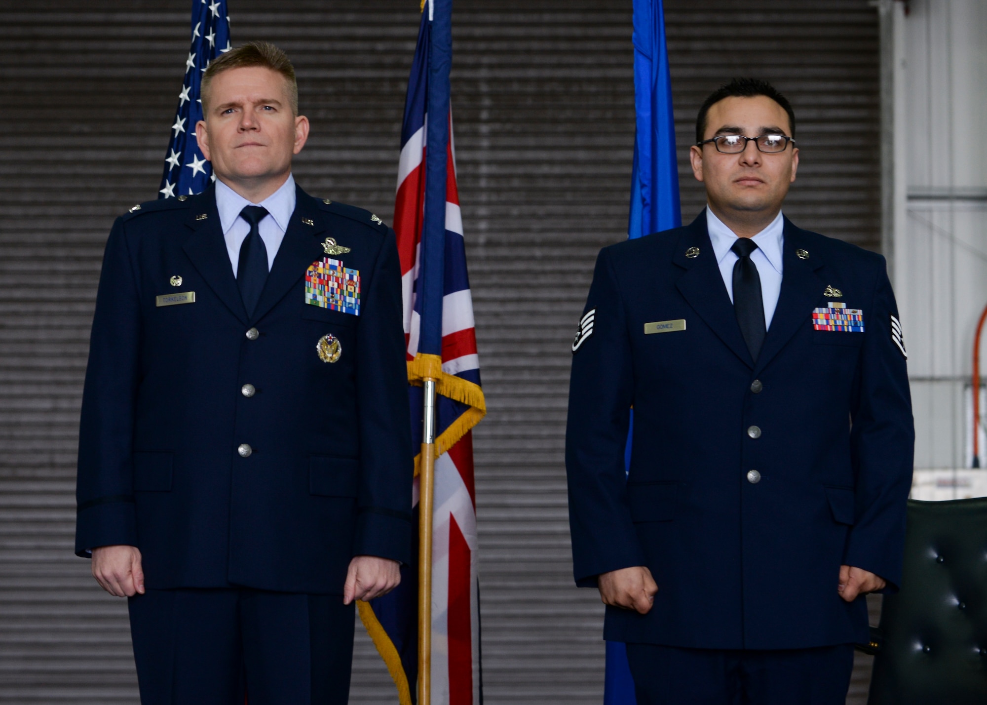 U.S. Air Force Col. Thomas D. Torkelson, 100th Air Refueling Wing commander, left, and Staff Sgt. Vicente Gomez, 100th Aircraft Maintenance Squadron crew chief, stand at the position of attention during a ceremony March 11, 2016, on RAF Mildenhall, England. Gomez was presented with the Airman’s Medal for risking his life to save two others near RAF Mildenhall on May 12, 2014. (U.S. Air Force photo by Senior Airman Victoria H. Taylor/Released)