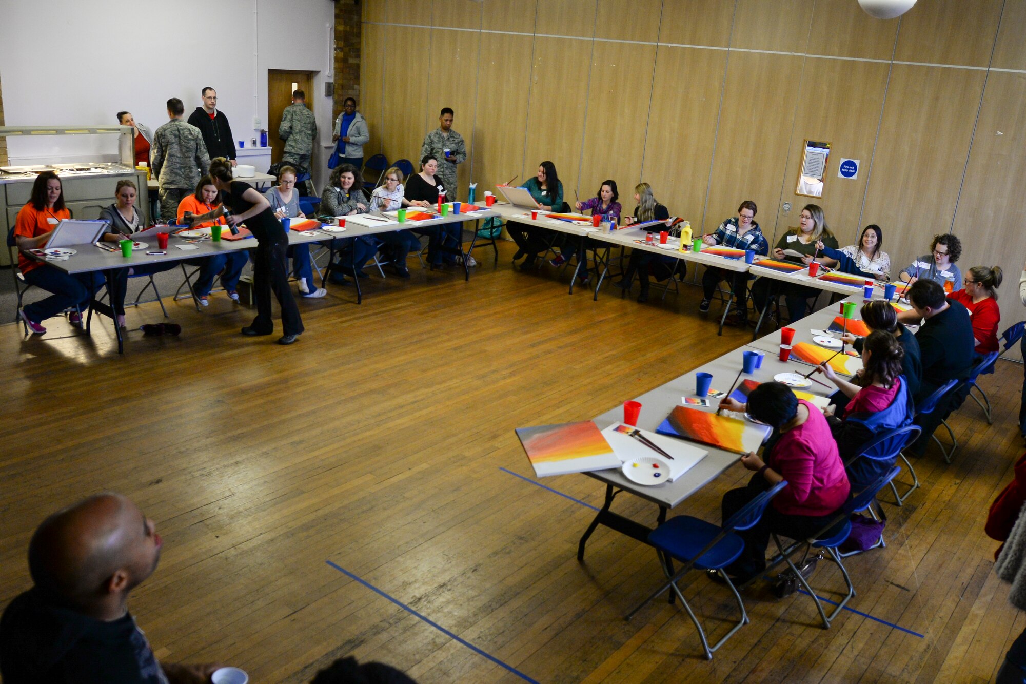 Team Mildenhall spouses paint canvases during a Hearts Apart event for families of deployed Airmen March 10, 2016, at the Bob Hope Community Center on RAF Mildenhall, England. This month the RAF Mildenhall Top Three Fellowship hosted the monthly event which helps bring Team Mildenhall families closer together during times of separation. (U.S. Air Force photo by Staff Sgt. Micaiah Anthony/Released)