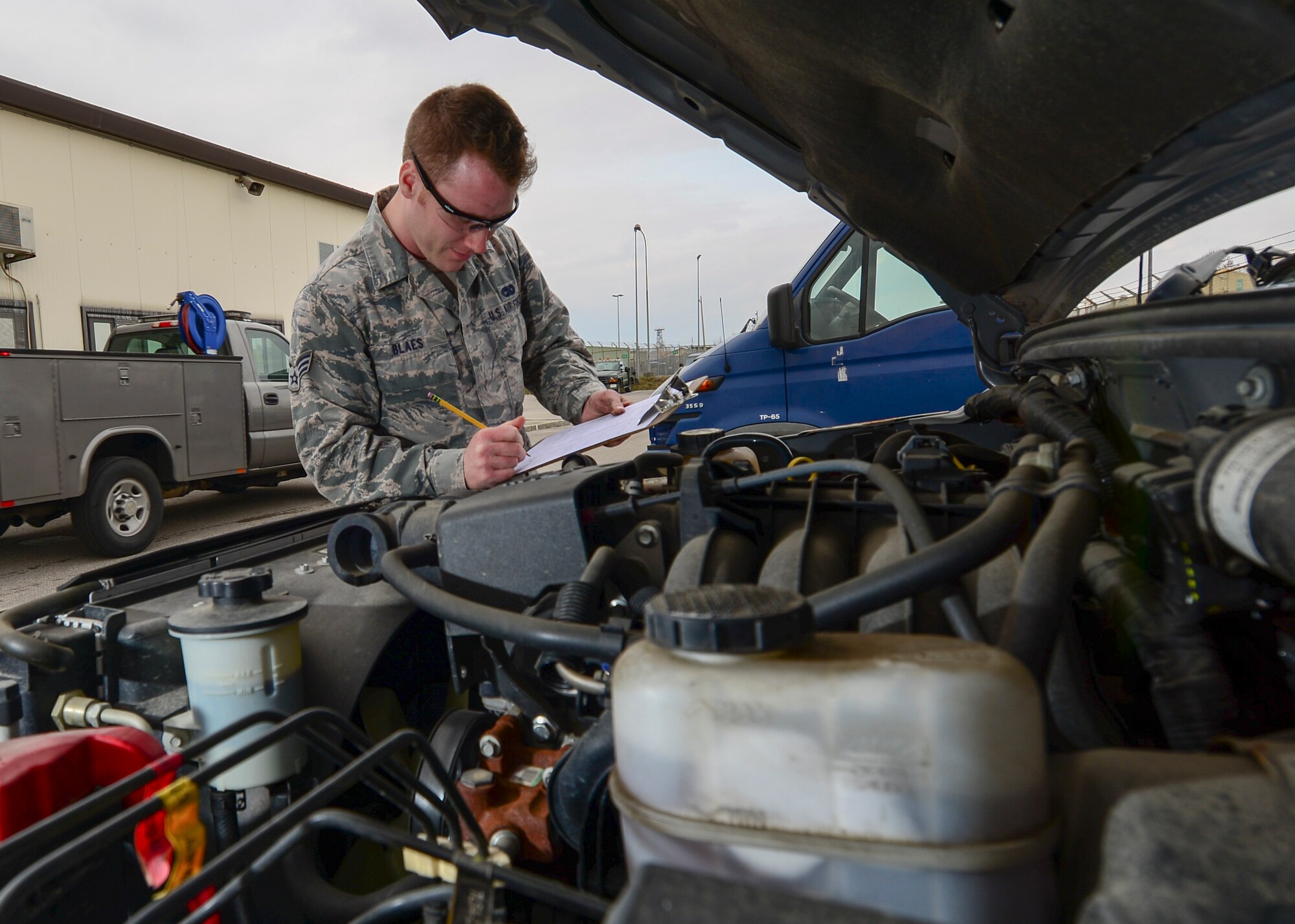 Senior Airman, Benjamin Blaes, 31st Logistics Readiness Squadron vehicle maintenance journeyman, performs an inspection on a vehicle March 2, 2015, at Aviano Air Base, Italy. The vehicle maintenance flight is responsible for performing maintenance on more than 790 Government-Owned Vehicles registered to Aviano. (U.S. Air Force photo by Airman 1st Class Cory W. Bush/Released)