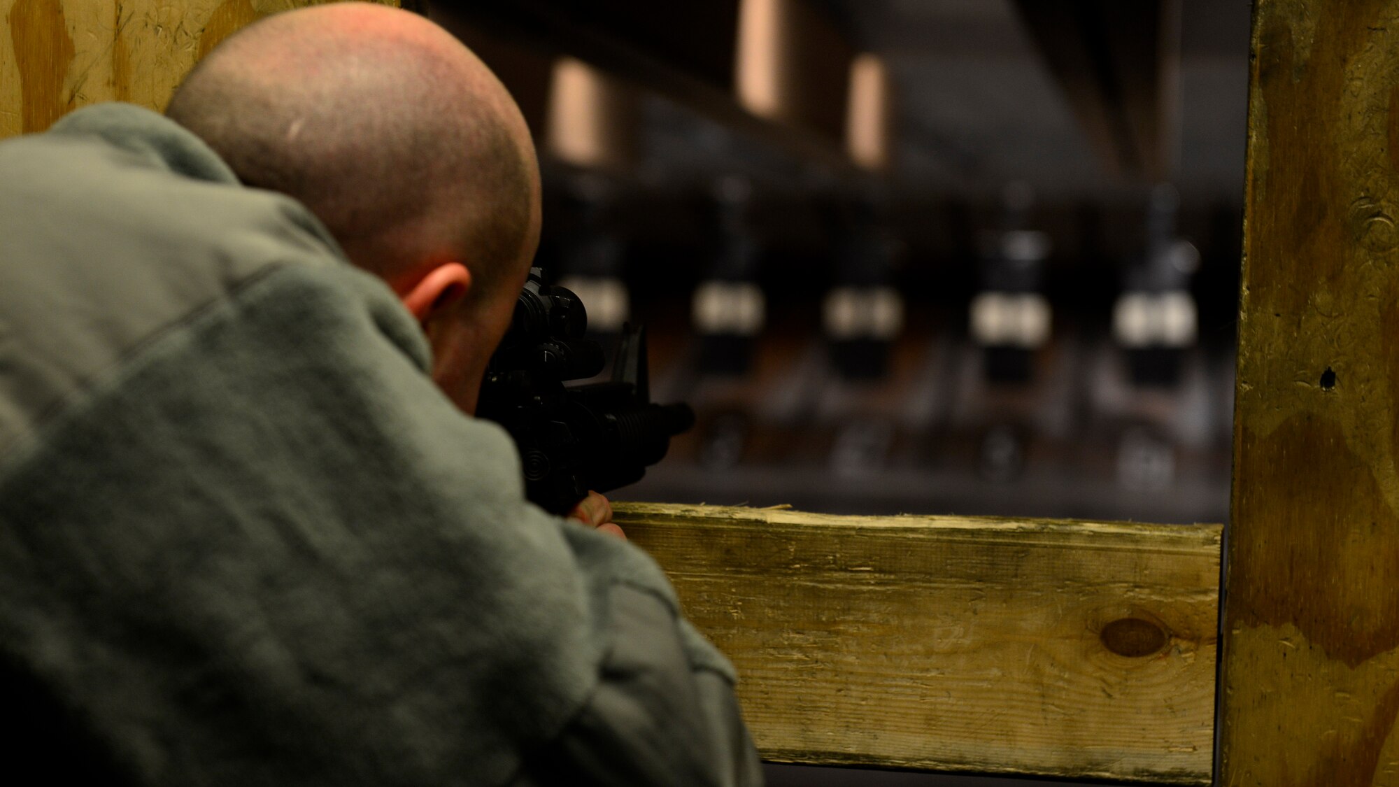 Tech. Sgt. Matthugh Crosby, 31st Fighter Wing Security occupational safety craftsman, aims at his target during qualification training, March 9, 2016, at Aviano Air Base, Italy. Airmen learned basic firing principles and qualified on the firing range with both iron and laser sights. (U.S. Air Force photo by Ariman 1st Class Cary Smith/Released)
