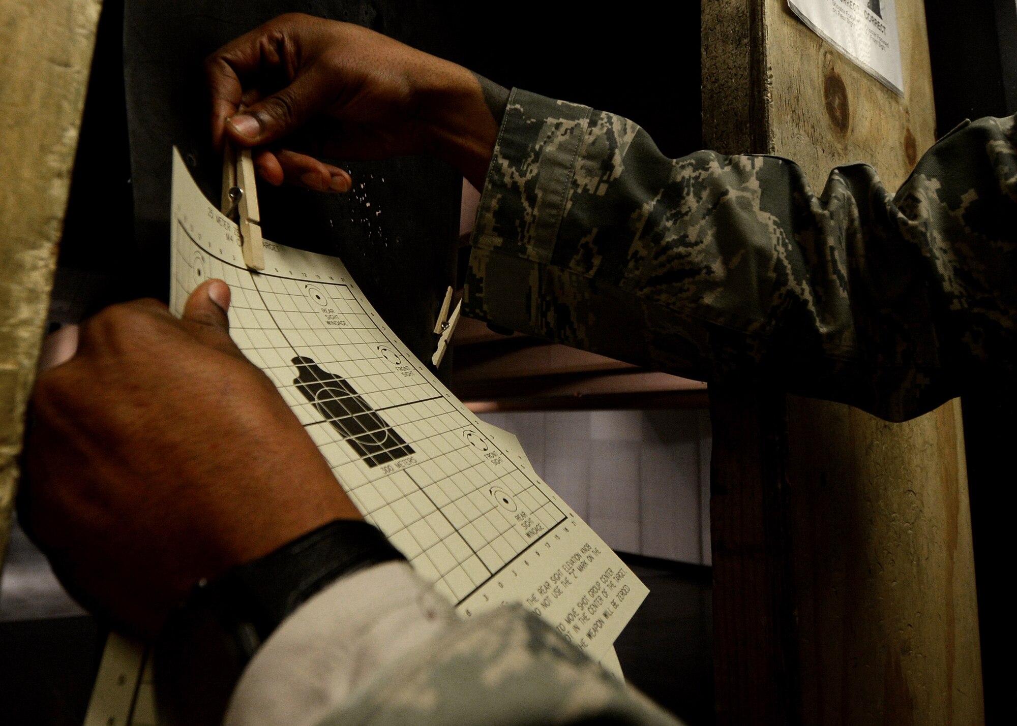 Tech. Sgt. Taron Blackman, 31st Security Forces Squadron command support staff NCO in charge, reloads his M4 carbine during qualification training, March 9, 2016, at Aviano Air Base, Italy. Airmen learned basic firing principles and qualified on the firing range with both iron and laser sights. (U.S. Air Force photo by Ariman 1st Class Cary Smith/Released)