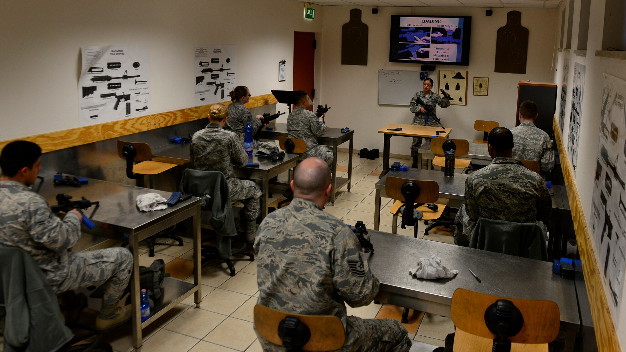 Staff Sgt. Alejandra Stutts, 31st Security Forces Squadron combat arms training and maintenance instructor, teaches Airmen how to properly properly handle and function check the M4 carbine, March 9, 2016, at Aviano Air Base, Italy. The instructions included firing techniques, clearing a jam and checking for malfunctions. (U.S. Air Force photo by Ariman 1st Class Cary Smith/Released)