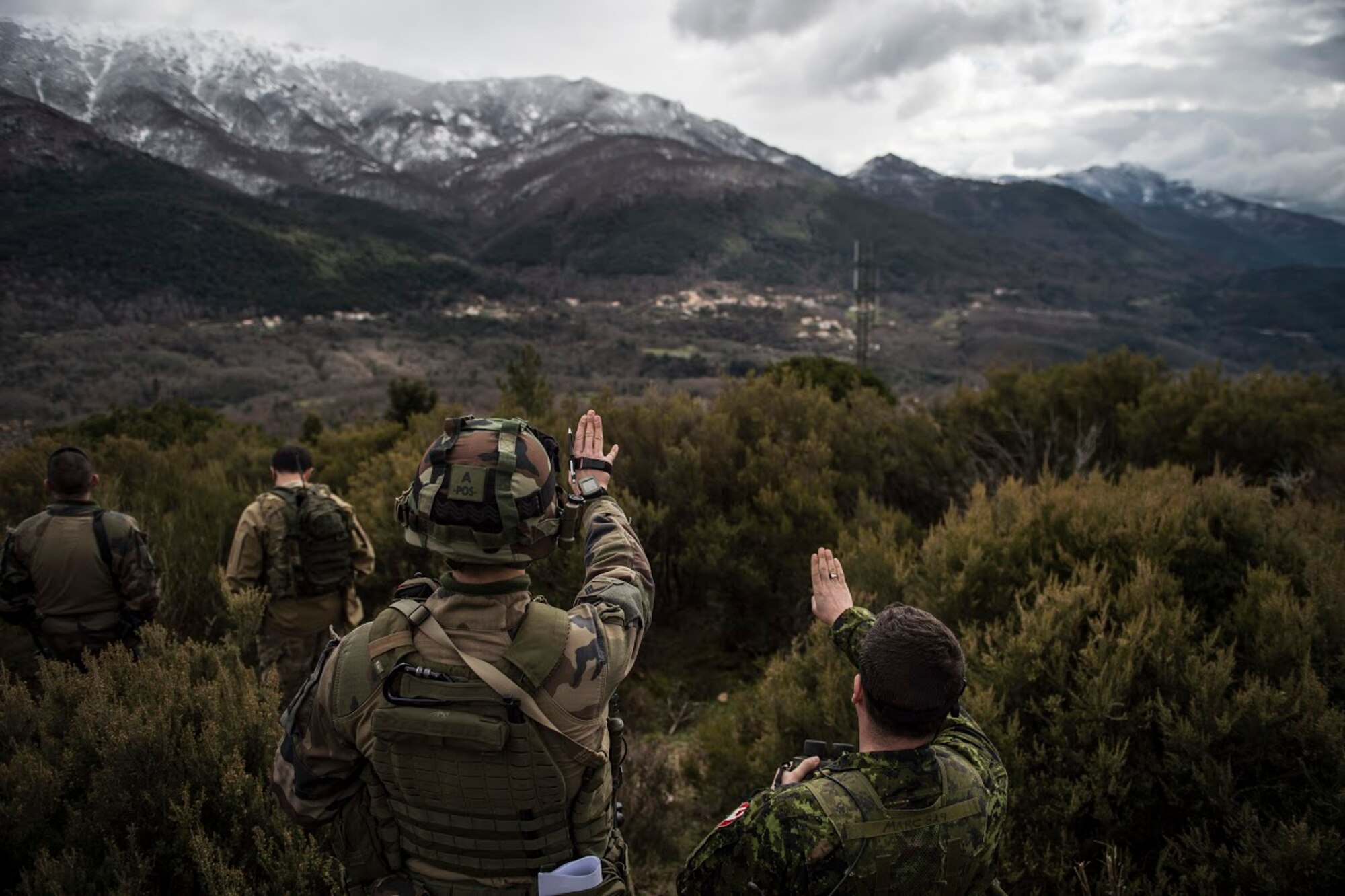 Master Bombardier Mathiew Marcoux-Desrochers, a joint terminal attack controller from the Yankee Battery of the 2nd Regiment, Royal Canadian Horse Artillery, helps Staff Sgt. Francois “Fix” Xavier, French Army joint terminal attack controller in training, with giving directions in English during exercise Serpentex 16, March 7, 2016. All JTACs, regardless of the country they serve are required to speak English to ensure they are able to give pilots correct directions and coordinates no matter where they are in the world. (U.S. Air Force photo/Staff Sgt. Sara Keller)