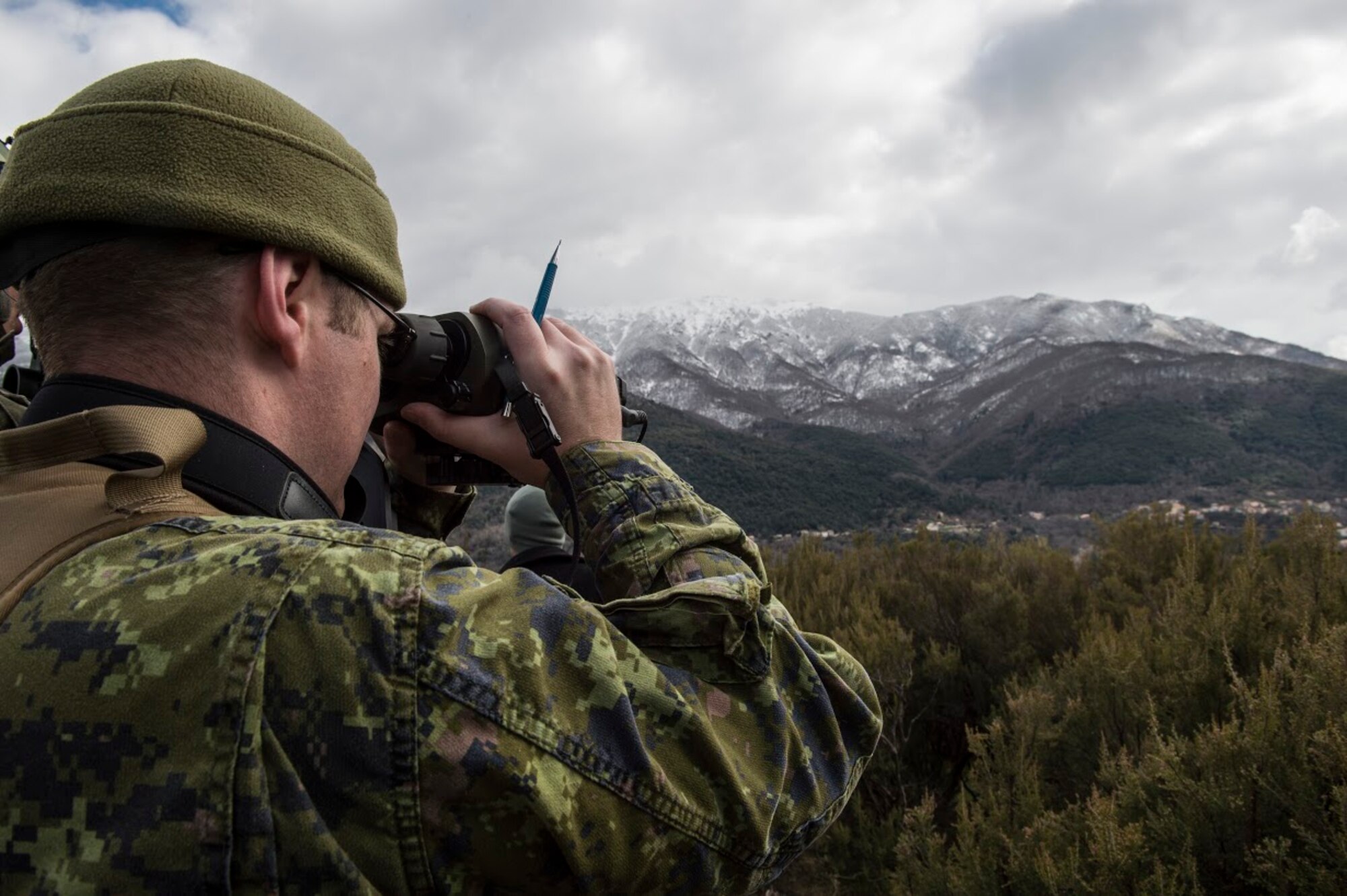Sgt. Lane Starling, 1st Regiment, Royal Canadian Horse Artillery joint terminal attack controller, scans the area and speaks to a pilot as part of a JTAC training scenario during exercise Serpentex 16, March 9, 2016. JTACs provide terminal control of both air and surfaced-based fires at the tactical level.  Approximately 215 Airmen, including JTACs from the 2nd Air Support Operations Squadron, from Vilseck, Germany are participating in the annual exercise held at NATO’s tactical training center and the French Air Force’s Air Base 126 Solenzara, France. (U.S. Air Force/Staff Sgt. Sara Keller)
