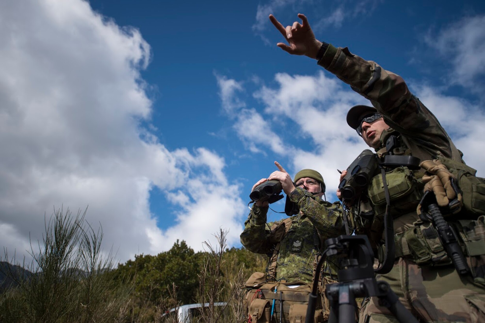 Master Bombardier Mathiew Marcoux-Desrochers, a joint terminal attack controller from the Yankee Battery of the 2nd Regiment, Royal Canadian Horse Artillery, helps Staff Sgt. Francois “Fix” Xavier, French Army joint terminal attack controller in training, with giving directions in English during exercise Serpentex 16, March 7, 2016. All JTACs, regardless of the country they serve are required to speak English to ensure they are able to give pilots correct directions and coordinates no matter where they are in the world. (U.S. Air Force photo/Staff Sgt. Sara Keller)