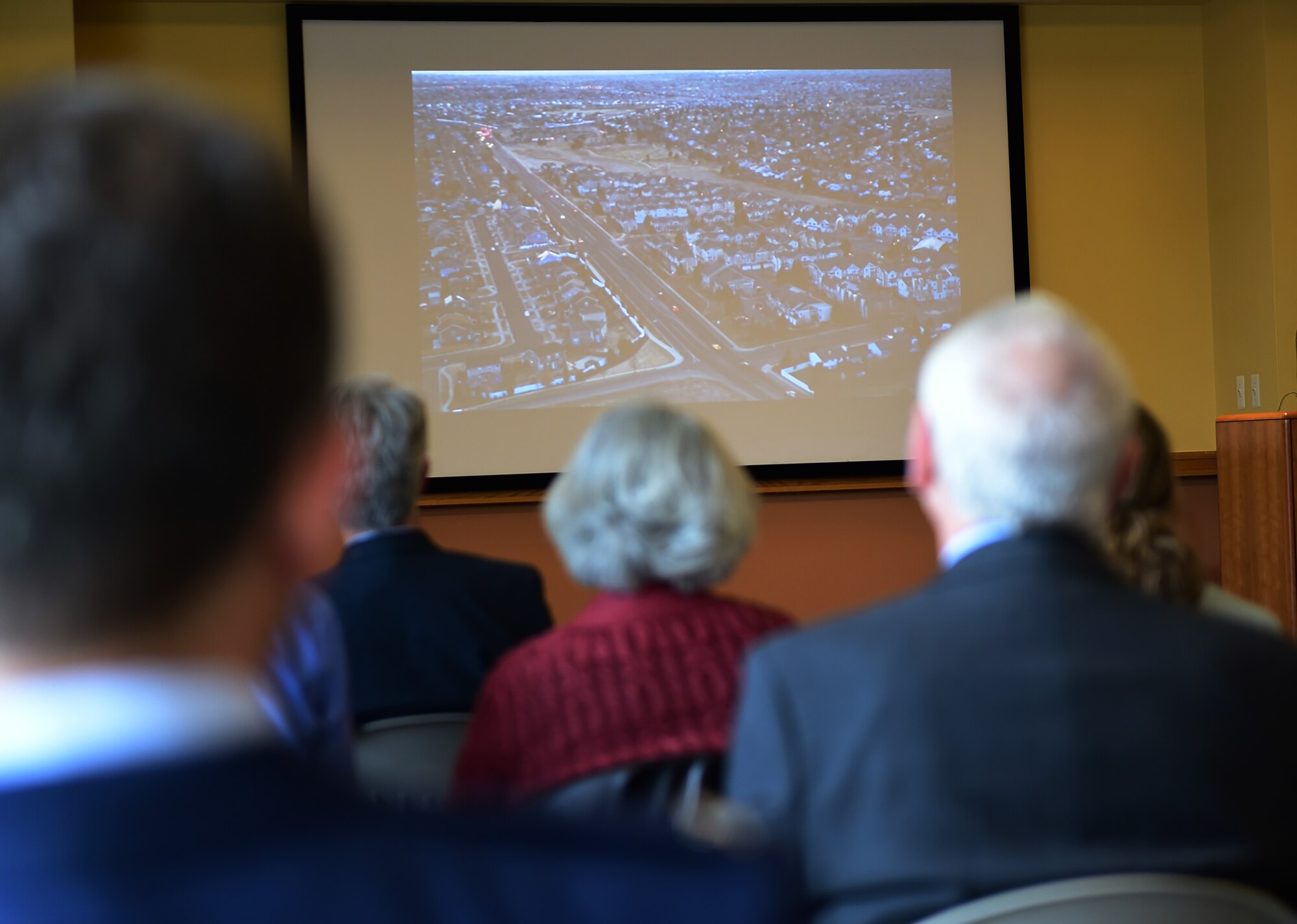 Arapahoe County citizens watch a Readiness and Environmental Protection Integration program video describing the importance of an easement around Buckley Air Force Base March 9, 2016, at the Arapahoe Center Point Plaza in Aurora, Colo. This is the first of a series of land conservation efforts designed to buffer the base. (U.S. Air Force photo by Senior Airman Racheal E. Watson/Released)