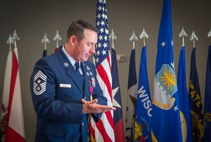 Chief Master Sgt. Vance Kondon pauses during his retirement speech at the Community Commons on Joint Base Andrews, Md., March 11, 2016. The Chief retired after 30 years of service, spending two years as command chief at JBA. (U.S. Air Force photo by Senior Airman Mariah Haddenham / Released)