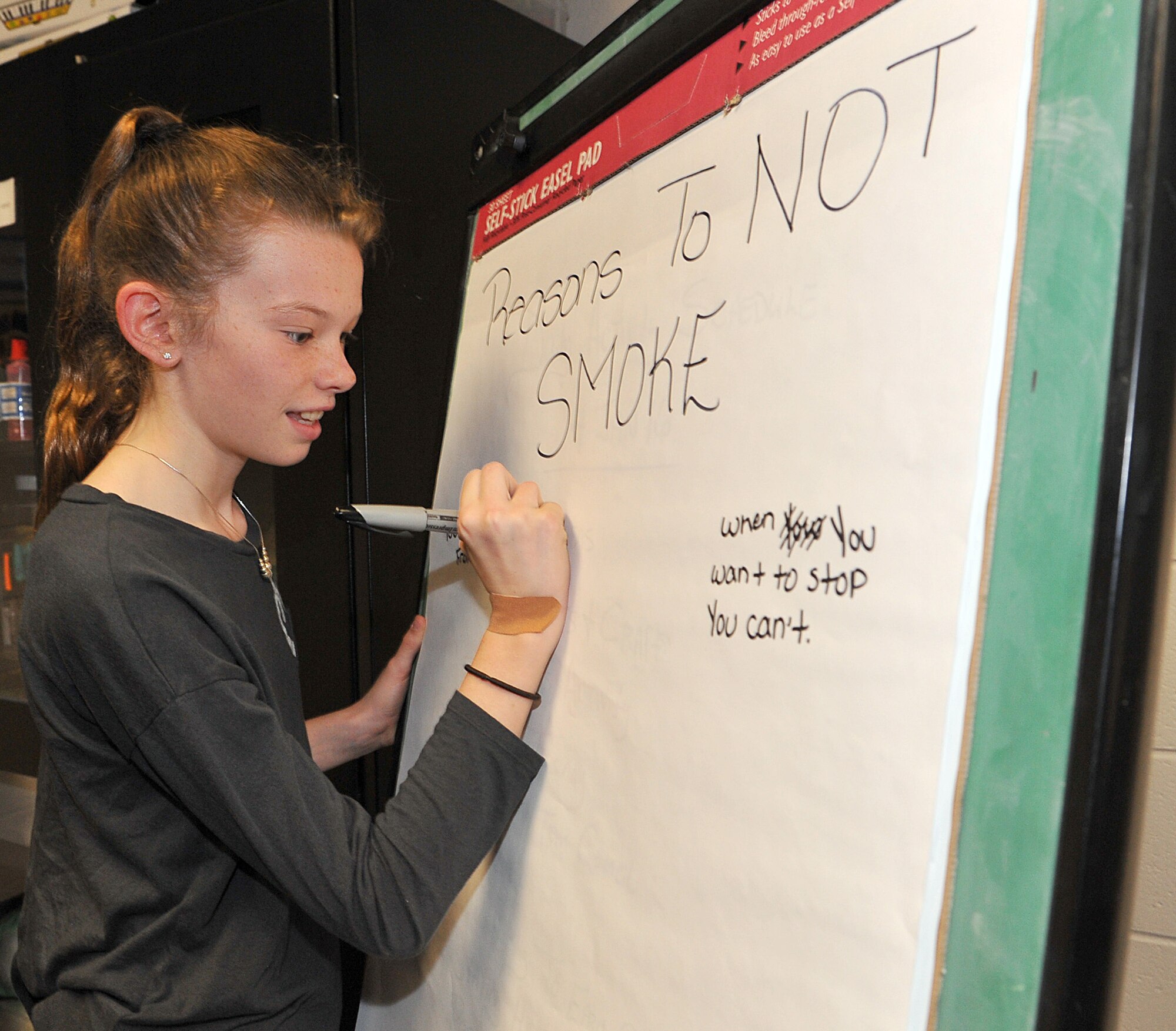 Ashley Hawkins, 10, takes notes during an antismoking discussion at the Robins Youth Center. (U.S. Air Force photo by Tommie Horton)