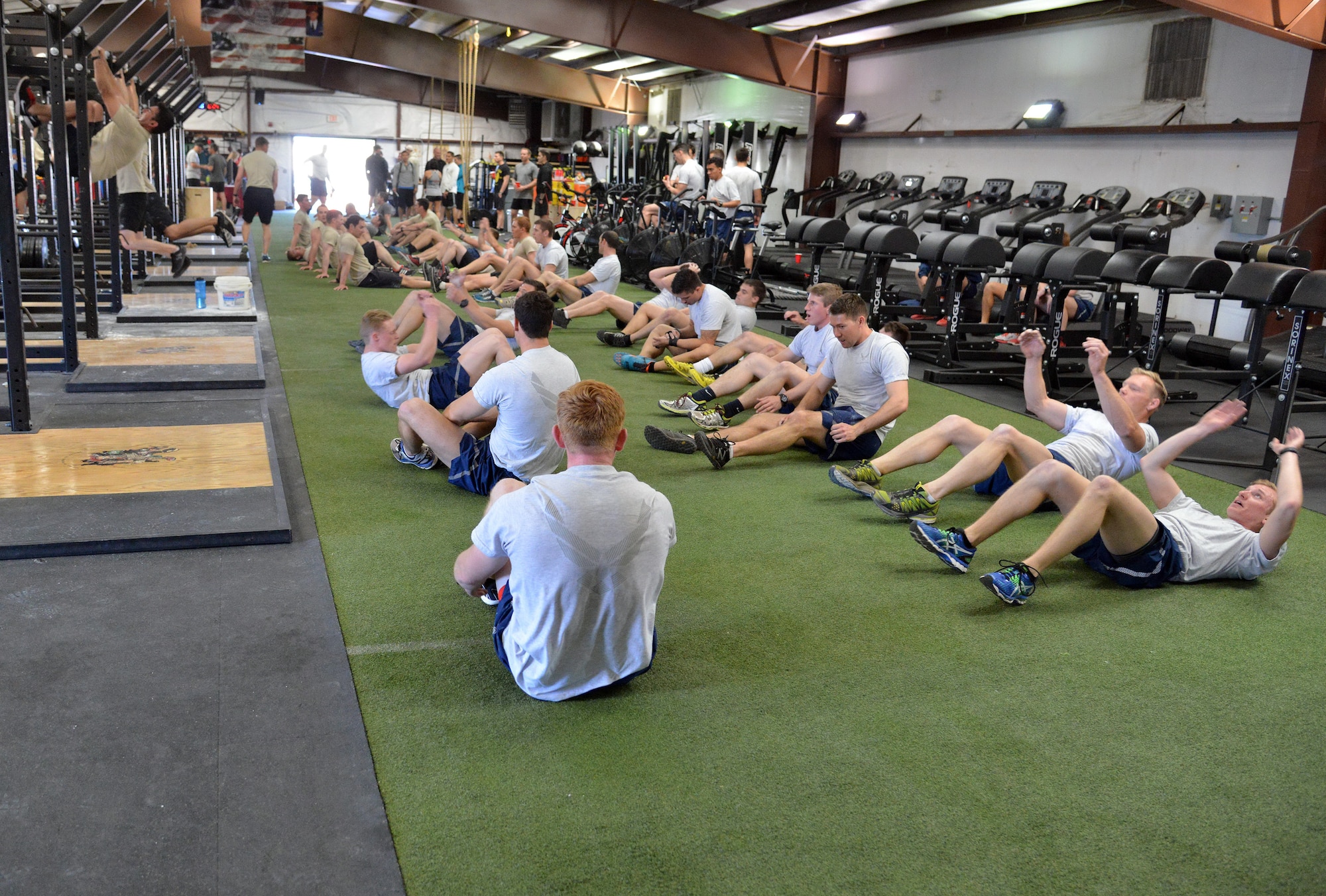 Participants in the DEA Maltz Challenge compete in the situp competition March 11 at Kirtland’s Air Force Pararescue School gym. The fitness competition is held annually in honor of fallen heroes with local ties. (Photo by Jamie Burnett) 