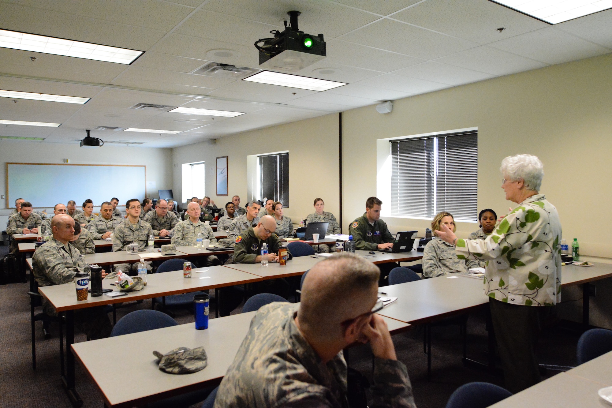 Maggie Bonner, a protocol special event management and intrnational relations specialist for the U.S. Air Force Services Agency, teaches airmen from the 139th Airlift Wing about protocol at Rosecrans Air National Guard Base in St. Joseph, Mo. on March 10, 2016. Bonner has been teaching protocol for 59 years. (U.S. Air National Guard photo by Senior Airman Bruce Jenkins/Released)