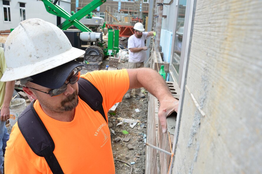 MCGHEE TYSON AIR NATIONAL GUARD BASE, Tenn. - Two brickmasons lay brick around the windows of building A here, March 9, 2016, at the I.G. Brown Training and Education Center. (U.S. Air National Guard photo by Master Sgt. Jerry D. Harlan/Released)
