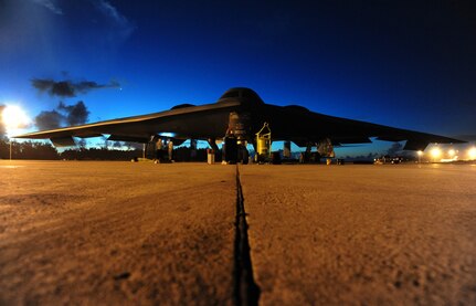 Crew chiefs with the 393rd Aircraft Maintenance Unit prepare to tow a U.S. B-2 Spirit bomber, March 11, 2016, in the U.S. Pacific Command area of operations. Bomber training missions and deployments ensure crews maintain a high state of readiness and proficiency and demonstrate the ability to provide an always-ready global strike capability. (U.S. Air Force photo by Senior Airman Joel Pfiester/Released)