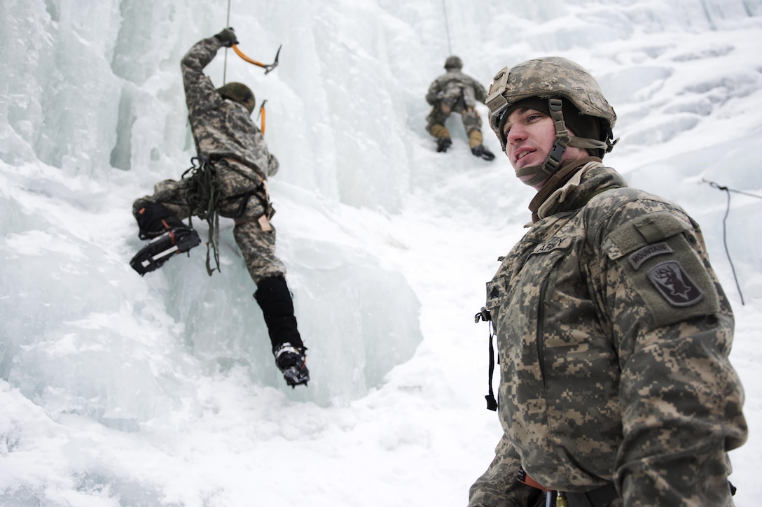 Army Sgt. Kyle Lebeau, foreground, supervises soldiers climbing an ice wall at Smugglers' Notch in Jeffersonville, Vt., March 5, 2016. Lebeau is a fire team leader assigned to Company A, 3rd Battalion, 172nd Infantry Regiment, 86th Infantry Brigade Combat Team, Mountain. Vermont Army National Guard photo by Staff Sgt. Nathan Rivard