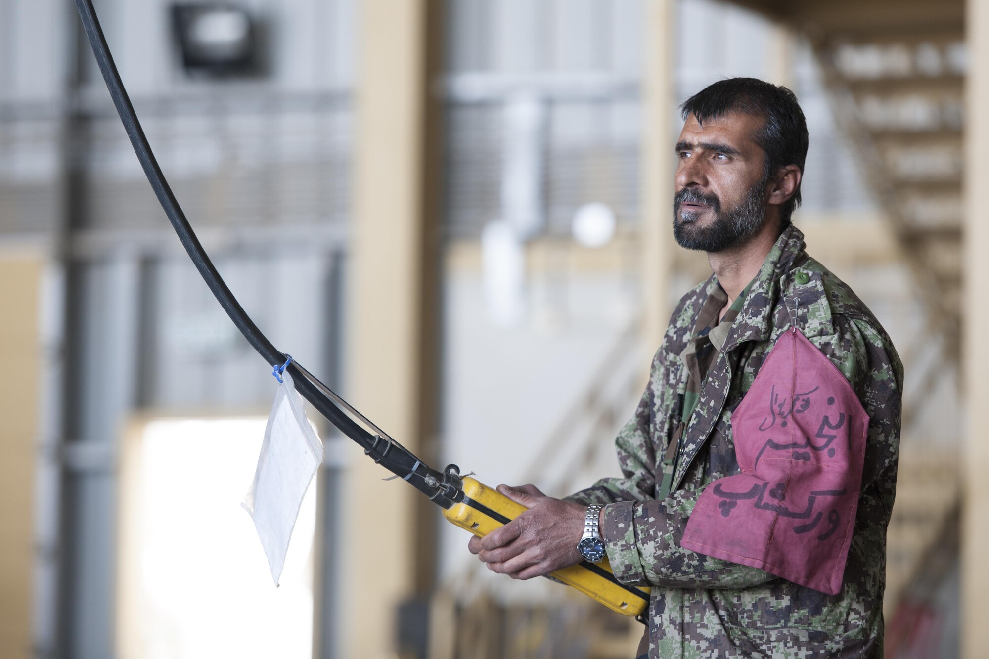 An Afghan Air Force member operates a crane to remove the blades of an Mi-17 helicopter during a 100-hour inspection at Kandahar Airfield, Afghanistan, March 2, 2016. Members of the AAF work closely with Train Advise Assist Command - Air, a U.S. run functional command, that assists our Afghan partners to develop a professional, capable and sustainable force. (U.S. Air Force photo/Tech. Sgt. Robert Cloys)