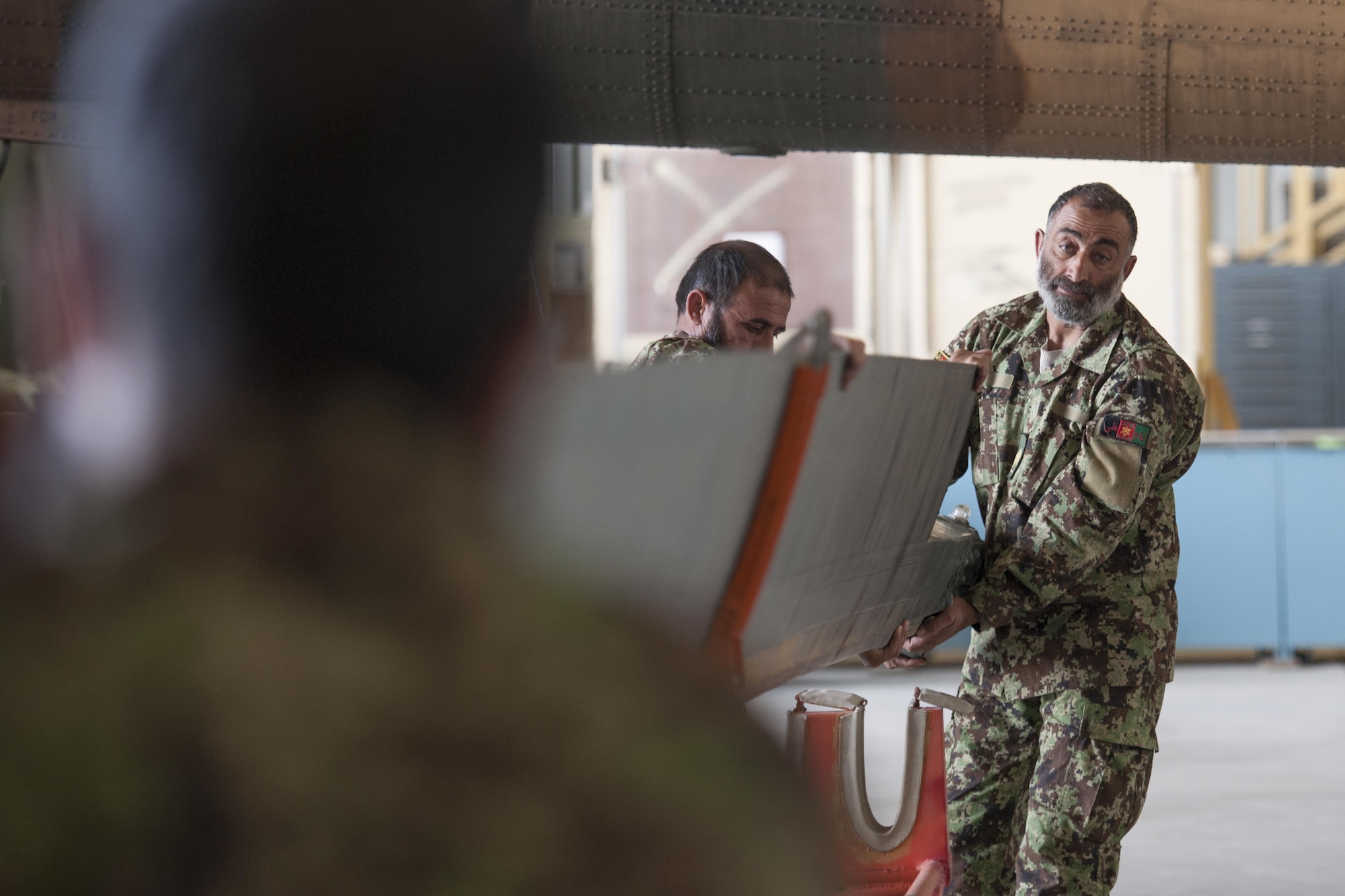 Afghan Air Force members store the recently removed blades of an Mi-17 helicopter during a 100-hour maintenance inspection at Kandahar Airfield, Afghanistan, March 2, 2016. Members of the AAF work closely with Train Advise Assist Command - Air, a U.S. run functional command, that assists our Afghan partners to develop a professional, capable and sustainable force. (U.S. Air Force photo/Tech. Sgt. Robert Cloys)