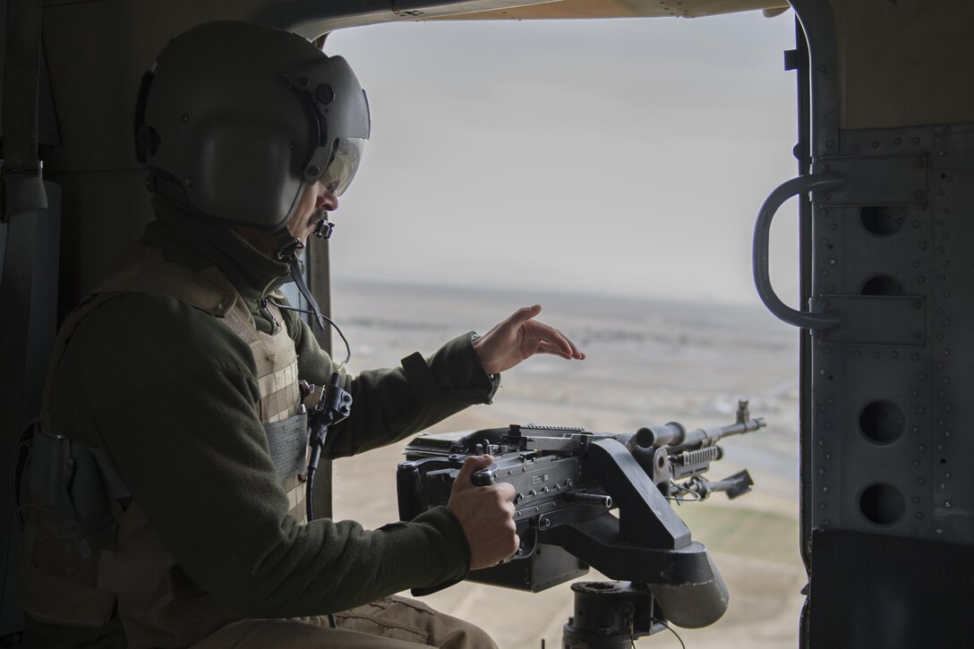 An Afghan Air Force Mi-17 aerial gunner from the Kandahar Air Wing scans the area during a take off, landing, and emergency-maneuver training mission near Kandahar Airfield, Afghanistan, March 3, 2016. Members of the Afghan Air Force at KAF are advised by Train Advise Assist Command - Air, a U.S. functional command that assists our Afghan partners to develop a professional, capable and sustainable force. (U.S. Air Force photo/Tech. Sgt. Robert Cloys)