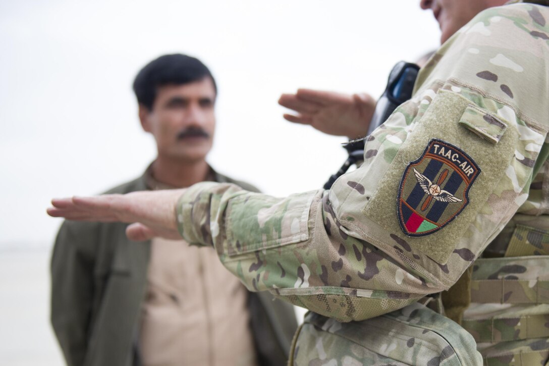 A Train Advise Assist Command - Air Mi-17 air advisor gives feedback to Afghan Air Force Mi-17 pilots after a training mission near Kandahar Airfield, Afghanistan, March 3, 2016. As a functional command, TAAC-Air assists our Afghan partners to develop a professional, capable and sustainable force. (U.S. Air Force photo/Tech. Sgt. Robert Cloys)