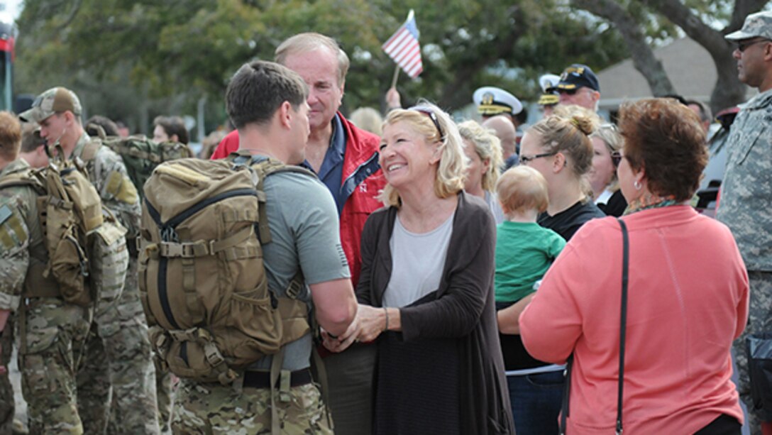 Marine Raider Nathan Harris, the founder and director of the Marine Raider Memorial March, greets supportive community members before the ruck begins.15 Marines and three civilians started a 770-mile ruck from Navarre, Florida, to Marine Corps Base Camp Lejeune, North Carolina to honor 11 service members who died in a Black Hawk crash one year ago.