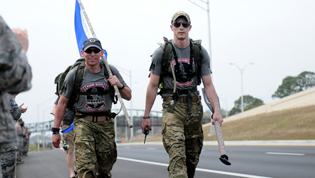 15 Marines and three civilians started a 770-mile ruck from Navarre, Florida, to Marine Corps Base Camp Lejeune, North Carolina to honor 11 service members who died in a helicopter crash one year ago. Two of the ruckers, including Marine Staff Sgt. Justin Bentley (right), continue the ruck past Hurlburt Field, Florida. 