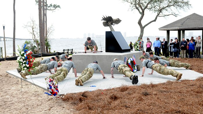 15 Marines and three civilians start a 770-mile ruck from Navarre, Florida, to Marine Corps Base Camp Lejeune, North Carolina to honor 11 service members who died in a helicopter crash one year ago. The Marines, led by Raider Nathan Harris, do some ceremonial push-ups at the memorial dedicated to the Raider 7. Shortly after, they began their 770-mile journey.