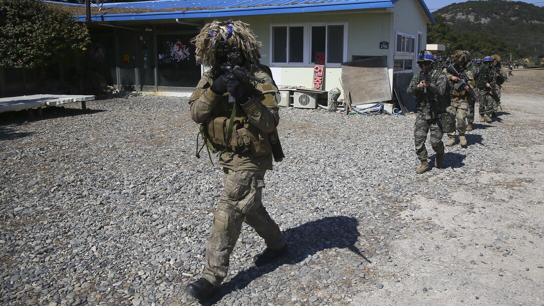 U.S. Marines, New Zealand Soldiers, Republic of Korea Marines and Australian Soldiers patrol prior during an amphibious assault rehearsal on Doksukri Beach, Republic of Korea, March 11, 2016, for Exercise Ssang Yong 16. Ssang Yong is a biennial military exercise focused on strengthening the amphibious landing capabilities of the ROK, the U.S., New Zealand and Australia.