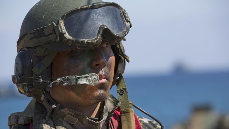 A Marine with the Republic of Korea Marine Corps listens to a brief for an amphibious assault rehearsal, on Doksukri Beach, Republic of Korea, March 11, 2016, for Exercise Ssang Yong 16. Ssang Yong is a biennial military exercise focused on strengthening the amphibious landing capabilities of the ROK, the U.S., New Zealand and Australia.