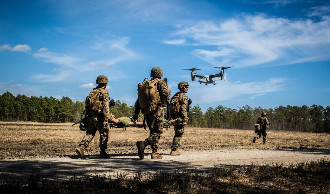 Marines with 2nd Combat Engineer Battalion, run to the landing point to load a casualty onto an MV-22B Osprey, during a casualty evacuation exercise at Landing Zone Penguin at Camp Lejeune, N.C., March 10, 2016. The training allowed Marines with Marine Medium Tiltrotor Squadron 365 and 2nd CEB to work together in order to be well prepared to conduct a successful CASEVAC in any situation they may encounter while deployed, to ultimately save lives.  (U.S. Marine Corps photo by Lance Cpl. Erick Galera/Released)