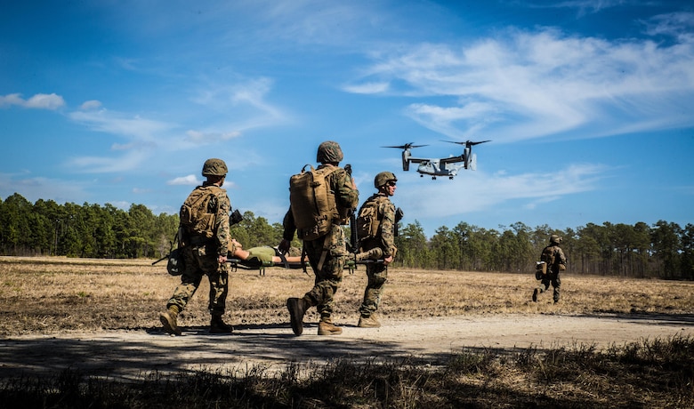 Marines with 2nd Combat Engineer Battalion, run to the landing point to load a casualty onto an MV-22B Osprey, during a casualty evacuation exercise at Landing Zone Penguin at Camp Lejeune, N.C., March 10, 2016. The training allowed Marines with Marine Medium Tiltrotor Squadron 365 and 2nd CEB to work together in order to be well prepared to conduct a successful CASEVAC in any situation they may encounter while deployed, to ultimately save lives.  (U.S. Marine Corps photo by Lance Cpl. Erick Galera/Released)