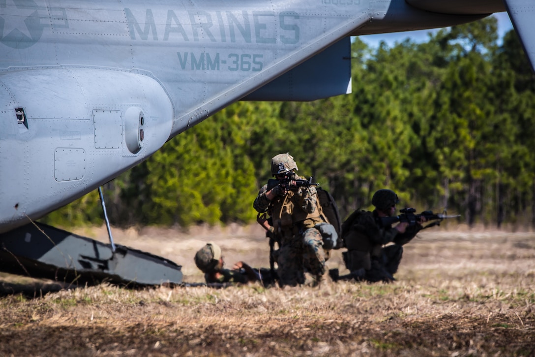 Marines with 2nd Combat Engineer Battalion, provide security before loading a casualty into a MV-22 Osprey during a casualty evacuation exercise at Landing Zone Penguin at Camp Lejeune, N.C., March 10, 2016. The training allowed Marines with Marine Medium Tiltrotor Squadron 365 and 2nd CEB to work together in order to be well prepared to conduct a successful CASEVAC in any situation they may encounter while deployed, to ultimately save lives.  (U.S. Marine Corps photo by Lance Cpl. Erick Galera/Released)