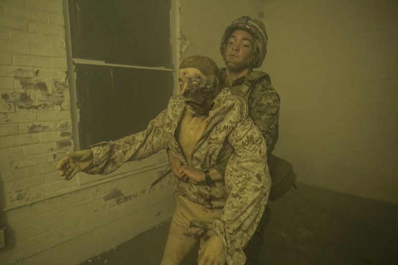 A sailor drags a mannequin to a staging area to preform life-saving care during a combat life-savers course at Camp Lejeune, N.C., March 10, 2016. This combat life-savers course simulated a combat zone, and included fog, fake blood and talking mannequins. (U.S. Marine Corps photo by Lance Cpl. Luke Hoogendam/Released.)