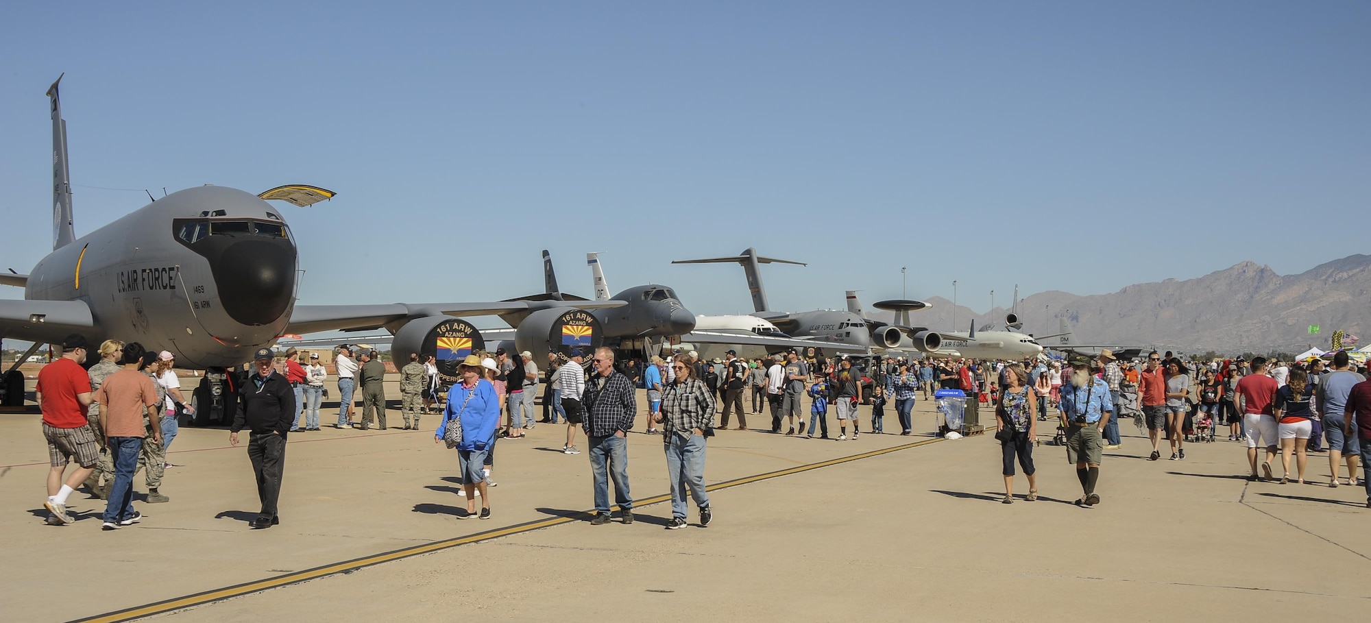 Spectators walk past C-5 Galaxy, B-1B Bomber and additional U.S. Air Force aircraft during the Thunder and Lightning over Arizona Open House at Davis-Monthan Air Force Base, Ariz., March 12, 2016. The Open House showcased military air power as well as gave the community members an opportunity to interact with D-M’s Airmen. There were 12 aerial demonstrations and 51 aircraft static displays showcased a day. (U.S. Air Force photo by Airman 1st Class Mya M. Crosby/Released)