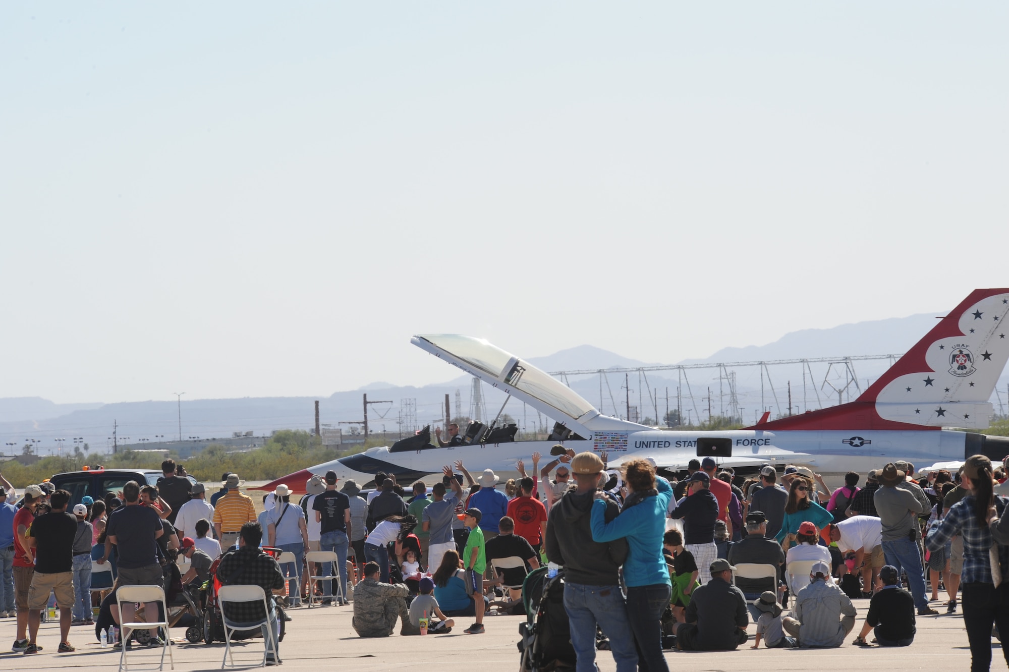 A U.S. Air Force F-16 Fighting Falcon from the U.S. Air Force Air Demonstration Squadron, the Thunderbirds, is towed past a waving crowd during the Thunder and Lightning over Arizona Open House at Davis-Monthan Air Force Base, Ariz., March 13, 2016. The open house featured 12 aerial demonstrations from various teams and more than 51 static displays allowing the public to gain a better understanding of the Air Force. (U.S. Air Force photo by Airman Nathan H. Barbour/Released)