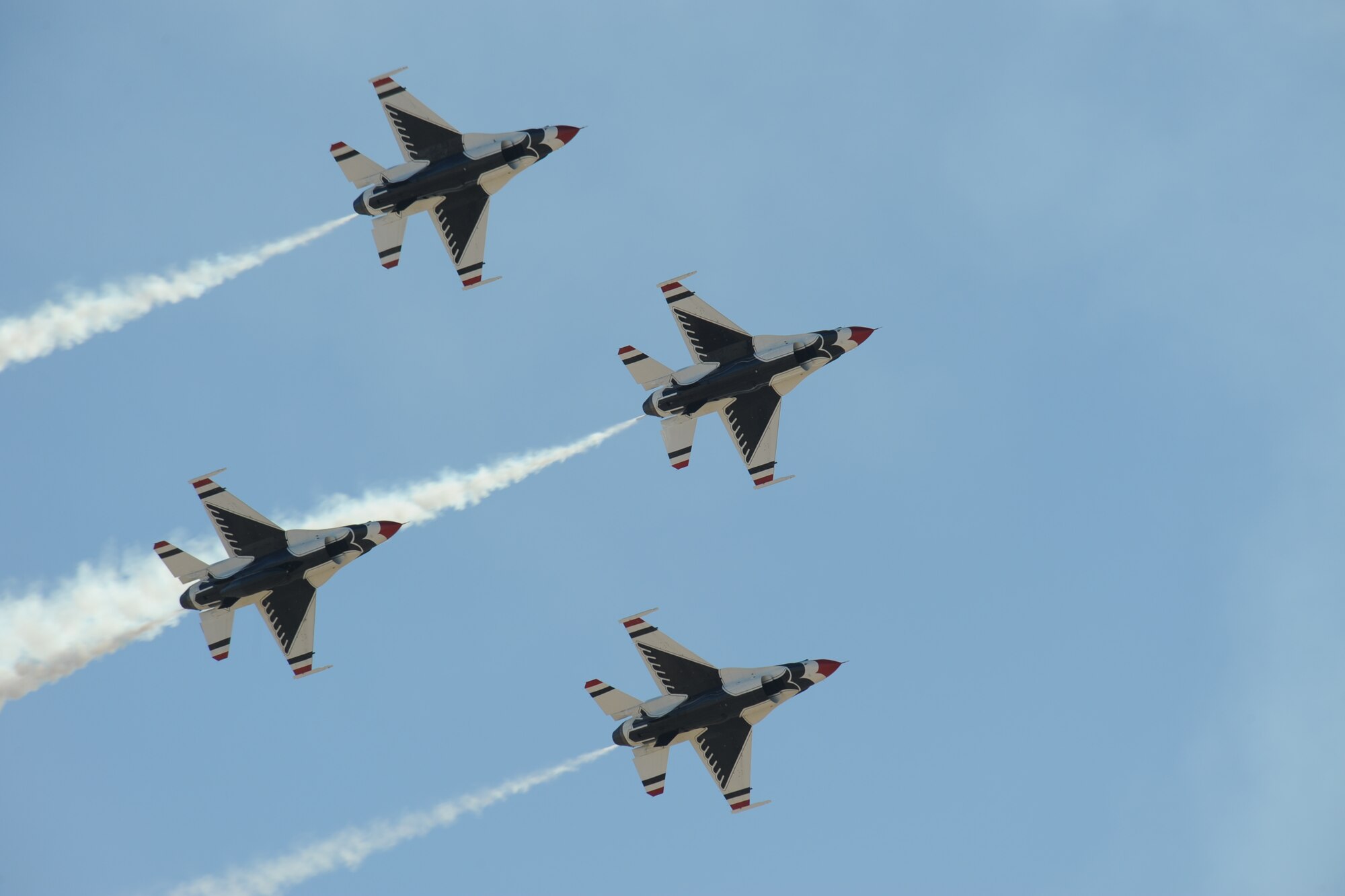 U.S. Air Force Air Demonstration Squadron, the Thunderbirds, flies over Davis-Monthan Air Force Base, Ariz., in a Diamond formation during the Thunder and Lightning over Arizona Open House March 13, 2016. The hour long demonstration gives spectators the chance to witness the precision maneuvers and capabilities the fighter pilots must possess into order to fly the F-16 Fighting Falcon.(U.S. Air Force photo by Airman Nathan H. Barbour/Released)