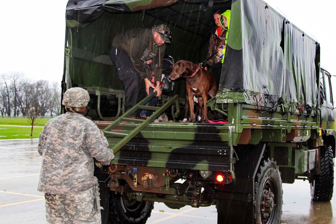 Louisiana National Guardsmen participating in flood response operations drop off evacuees at Parkway High School in Bossier City, La., March 9, 2016. The guardsmen are assigned to the Louisiana National Guard’s 1st Squadron, 108th Cavalry Regiment. Louisiana Army National Guard photo by Staff Sgt. Jerry W. Rushing