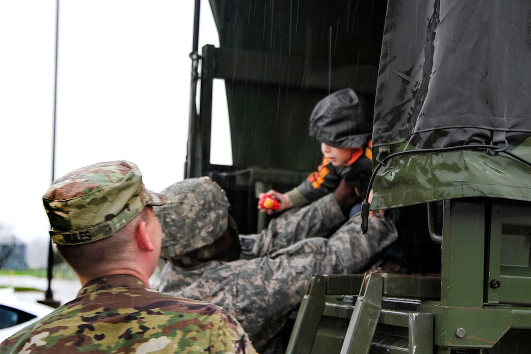 Louisiana National Guardsmen participating in flood response operations drop off a young boy at Parkway High School in Bossier City, La.,March 9, 2016. Louisiana Army National Guard photo by Staff Sgt. Jerry W. Rushing