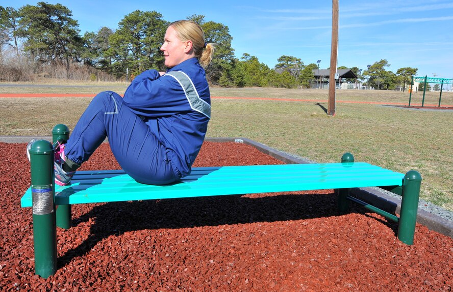 U.S. Air Force Tech. Sgt. Rosemarie Perry, inventory management technician with the 177th Fighter Wing Logistics Readiness Squadron, New Jersey Air National Guard, does sit-ups at a new workout station located alongside the on-base running track at the Atlantic City Air National Guard Base, N.J. on Mar. 3, 2016. New workout stations include: the back extension, horizontal bars, push up bars, a sit up bench, the sky climber (a variation of a horizontal ladder), and uneven bars, and can be used for high-intensity workouts including cardio and strength intervals. (U.S. Air National Guard photo by Master Sgt. Andrew J. Moseley/Released)