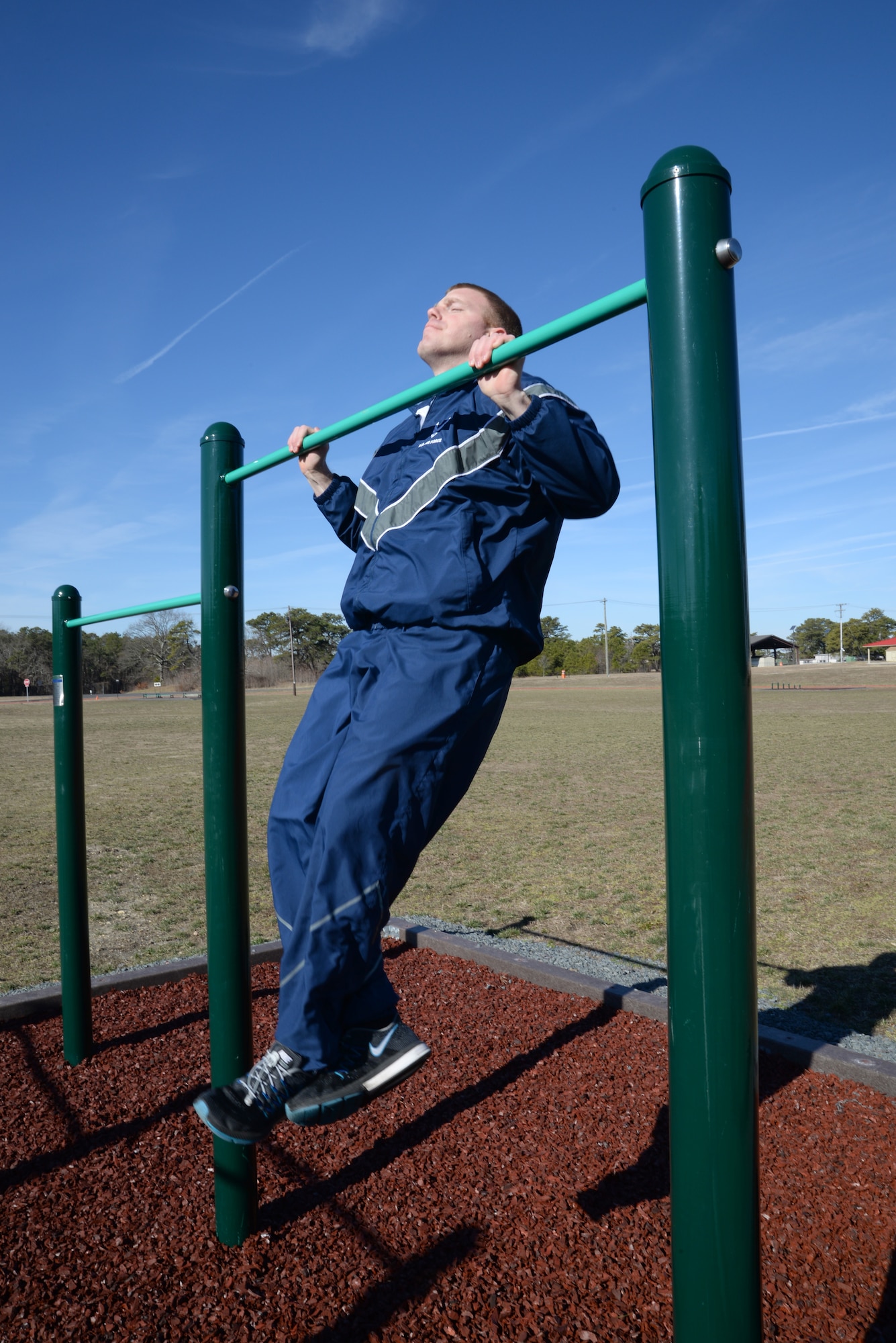 A picture of U.S. Air Force Tech. Sgt. Bob Johnson, management inspector with the 177th Fighter Wing Logistics Readiness Squadron of the New Jersey Air National Guard, doing chin-ups at a new workout station.