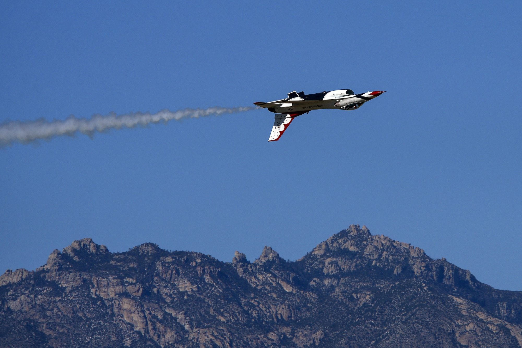 U.S. Air Force Maj. Alex Turner, USAF Air Demonstration Squadron opposing solo pilot, performs an inverted pass during the Thunder and Lightning over Arizona Open House event at Davis-Monthan Air Force Base, Ariz., March 12, 2016. The hour-long demonstration gave spectators the chance to witness the precise maneuvers and capabilities exhibited by these F-16 Fighting Falcon pilots. (U.S. Air Force photo by Senior Airman Chris Drzazgowski/Released)