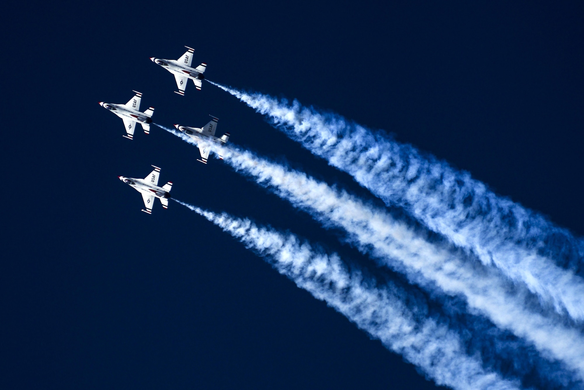 U.S. Air Force Air Demonstration Squadron, the Thunderbirds, fly at the top of an “Arrowhead Loop” maneuver during the Thunder and Lightning over Arizona Open House event at Davis-Monthan Air Force Base, Ariz., March 12, 2016. The hour-long demonstration gave spectators the chance to witness the precise maneuvers and capabilities exhibited by these F-16 Fighting Falcon pilots. (U.S. Air Force photo by Senior Airman Chris Drzazgowski/Released)