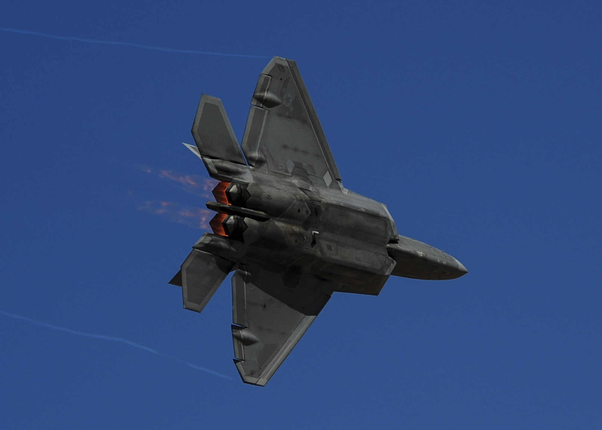 A U.S. Air Force F-22 Raptor banks left during the Thunder and Lightning over Arizona Open House event at Davis-Monthan Air Force Base, Ariz., March 12, 2016. The open house featured aerial demonstrations from various teams and numerous static displays allowing the public to gain a better understanding of the Air Force. (U.S. Air Force photo by Senior Airman Chris Drzazgowski/Released) 