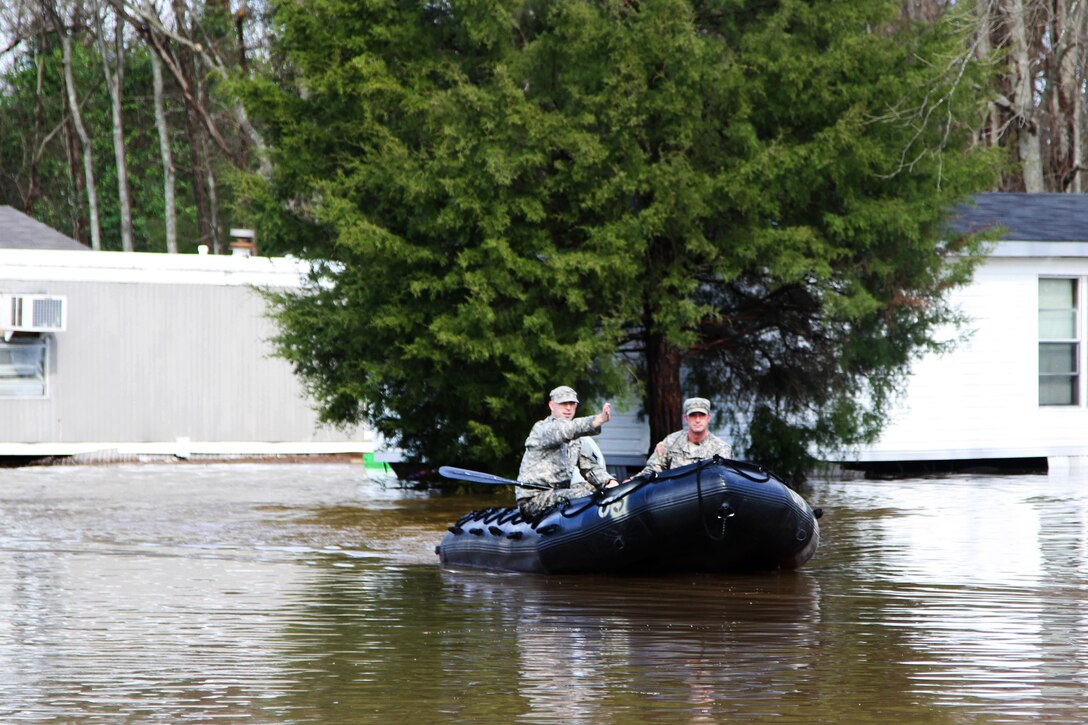 Army 2nd Lt. William Hall, left, and Cpl. Kurt Humpreys conduct a door-to-door search for stranded evacuees in a flooded neighborhood in Bossier City, La., March 10, 2016. Hall and Humpreys are assigned Louisiana National Guard's 2nd Squadron, 108th Cavalry Regiment. Louisiana Army National Guard photo by Staff Sgt. Jerry W. Rushing