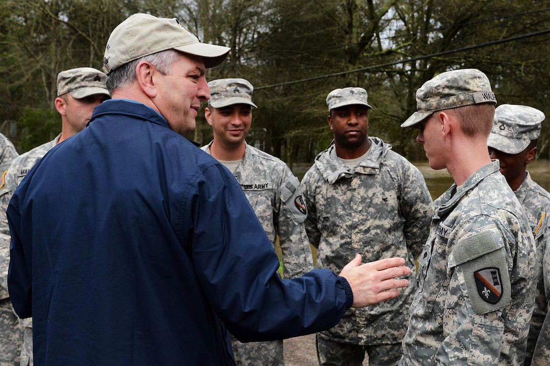 Louisiana Gov. John Bel Edwards, left, thanks guardsmen assisting local agencies around the clock during flood response operations in Ponchatoula, La., March 12, 2016. Louisiana Army National Guard photo