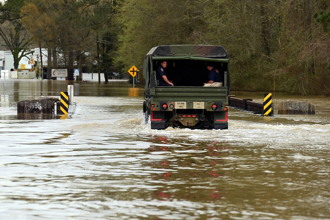 Guardsmen and local agencies drive through high waters to search for stranded residents during flood response operations in Ponchatoula, La., March 12, 2016. Louisiana Army National Guard photo