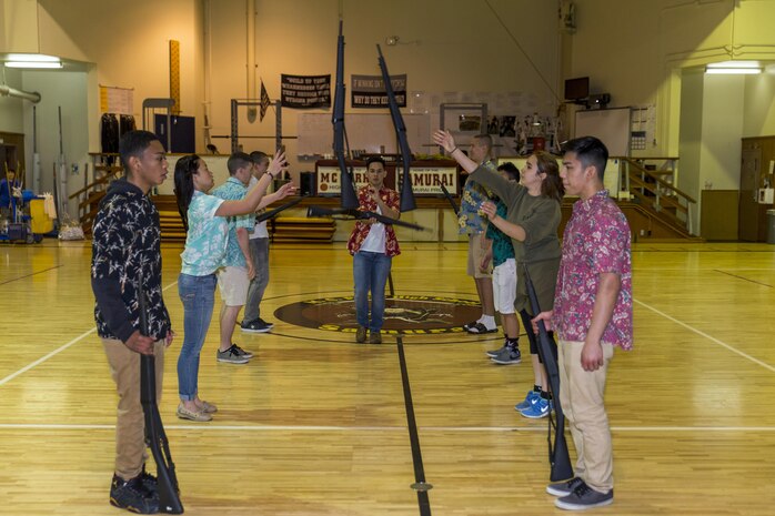 Junior Reserve Officer Training Corps cadets from Matthew C. Perry High School conduct drill practice at Marine Corps Air Station Iwakuni, Japan, March 9, 2016. The JROTC cadets took top honors during the Far East Marksmanship Competition at Camp Humphreys, Korea, Feb. 14-16, 2016, and the drill competition at Yokota Air Force Base, Japan, Nov. 16-18, 2015. During the drill competition, M.C. Perry cadets placed first in uniform inspection and armed regulation, second in unarmed and armed exhibitions, and third place in unarmed regulation and color guard. After finishing with two 3rd place victories, two 2nd place victories, and two 1st place victories, the cadets achieved 1st place overall. (U.S. Marine Corps photo by Lance Cpl. Aaron Henson/Released)