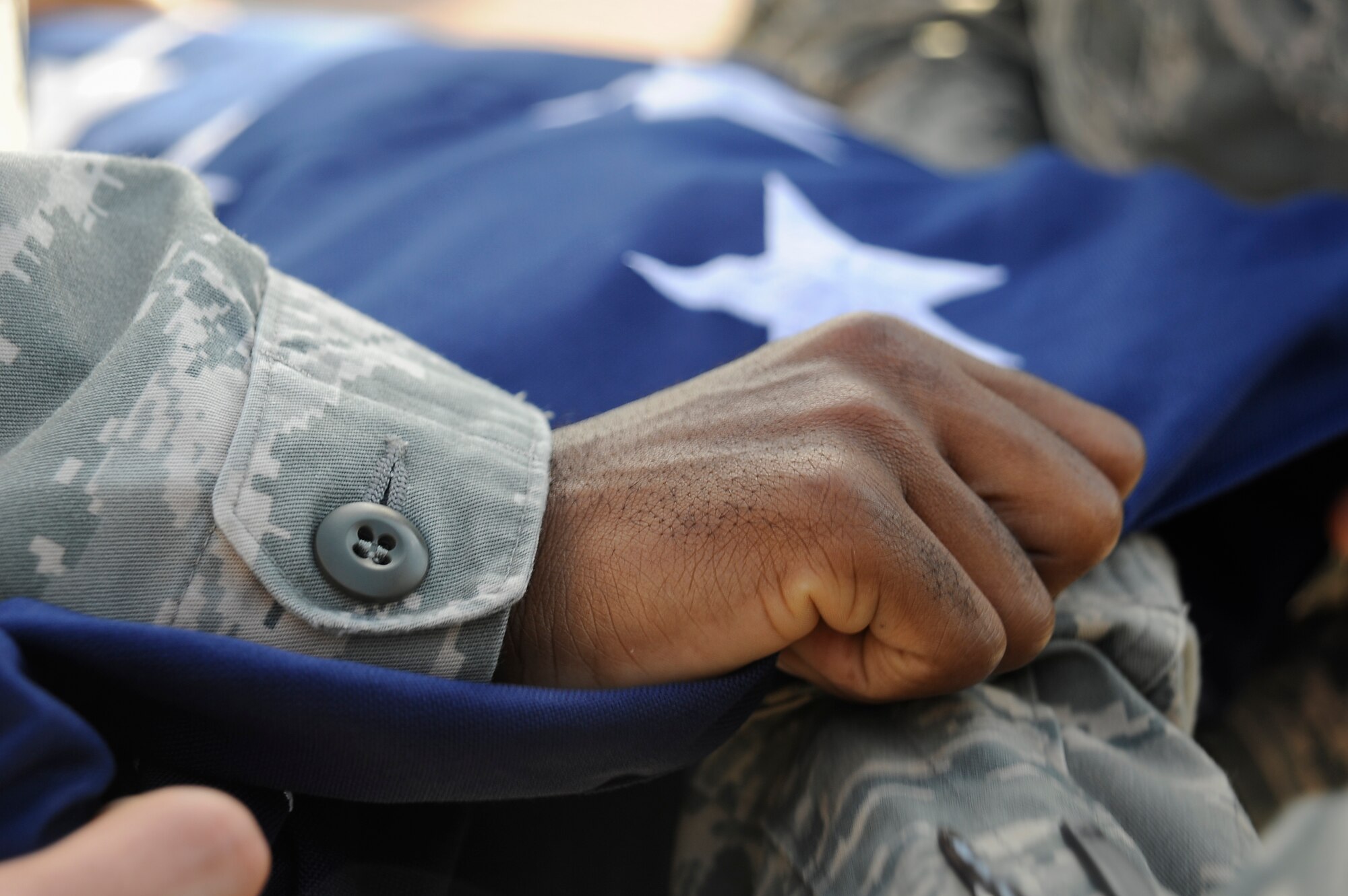 Staff Sgt. Dominique Lockley, a flag detail member, folds the American flag during a retreat ceremony at MacDill Air Force Base, Fla., March 9, 2016. Retreat is a time-honored event that has been performed for centuries. (U.S. Air Force photo by Airman 1st Class Mariette Adams)